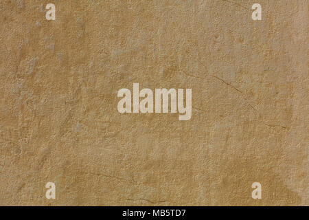 Weathered yellow plastered and painted wall background Stock Photo