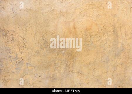 Weathered yellow plastered and painted wall background Stock Photo
