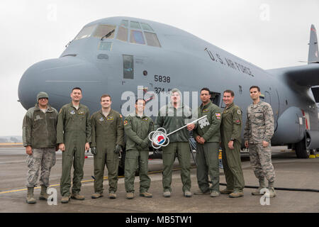 Members of the C-130J Super Hercules number 5838 delivery team pose for a photo at Yokota Air Base, Japan, Feb. 22, 2018. This is the eleventh C-130J delivered to Yokota as part of a fleet-wide redistribution of assets in motion by Air Mobility Command. Stock Photo