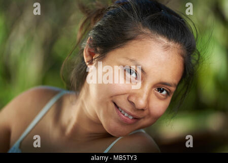 Latina young girl portrait smiling with teeth on blurred natural background Stock Photo