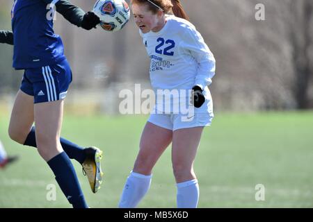 High school player executing a header in traffic. USA. Stock Photo
