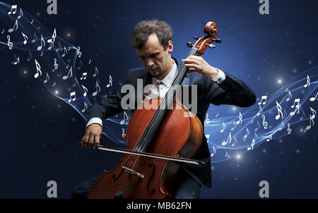 Lonely musical composer with cello and sparkling musical notes around Stock Photo