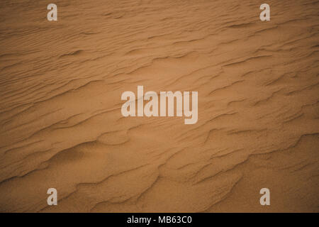 Ripples from the wind in orange desert sand in Huacachina, Peru Stock Photo