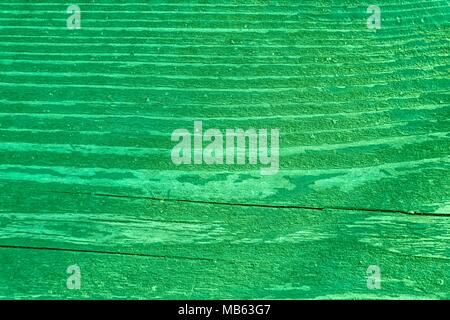 Golden lime colored Texture of old, shabby, green paint on an old wooden bench. Stock Photo