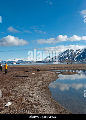 Walking along the shoreline in at Recherchéfjord Spitsbergen, Svalbard, Norway. Stock Photo