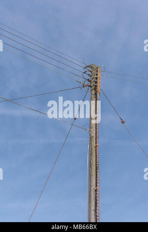 Local overhead domestic electricity distribution network pole to houses in Bodmin, Cornwall. Household electricity concept. Stock Photo