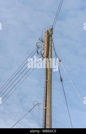 Local overhead domestic electricity distribution network pole to houses in Bodmin, Cornwall. Household electricity concept. Stock Photo