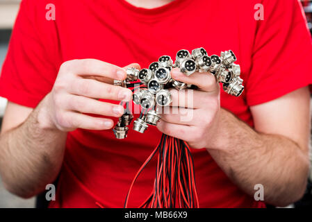four pin connectors with thread in hand Stock Photo