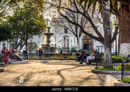 Antigua, Guatemala - March 30, 2018: Early morning vendors & tourists on Good Friday in central plaza in colonial city & UNESCO World Heritage Site Stock Photo