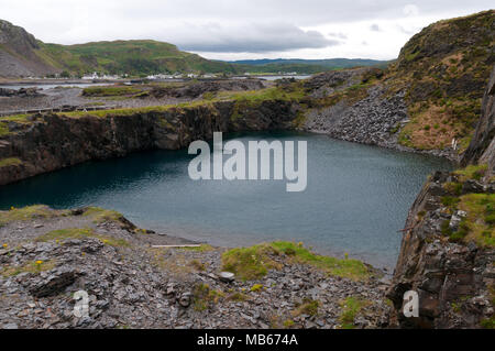 Slate Mining on Easedale, Slate Isles, Scotland with village of Ellenabiech on Seil in background Stock Photo