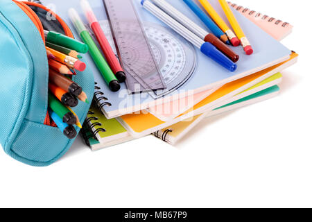 Various school supplies including notebooks and pencil case isolated against a white background Stock Photo