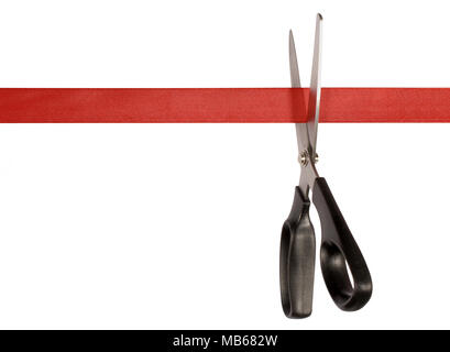 Scissors cutting red ribbon or tape against a white background Stock Photo