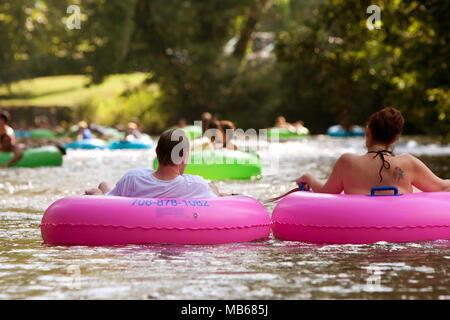 Helen, GA, USA - August 24, 2013:  A couple enjoys tubing down the Chattahoochee River with hundreds of others in North Georgia on a warm summer day. Stock Photo