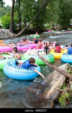 Helen, GA, USA - August 24, 2013:  Families enjoy tubing down the Chattahoochee River in North Georgia on a warm summer afternoon. Stock Photo