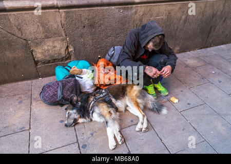 BARCELONA, SPAIN, JULY 5, 2017: Young unidentified man next to her pet, asking for money in some street of Barcelona Stock Photo