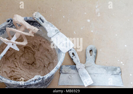 Construction tools on concrete background. Copy space for text. Set of assorted plaster trowel tools and spatula . Top view Stock Photo