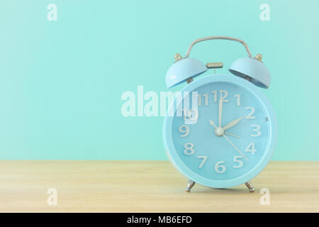 Image of spring Time Change. Summer back concept. Vintage alarm Clock over wooden table Stock Photo