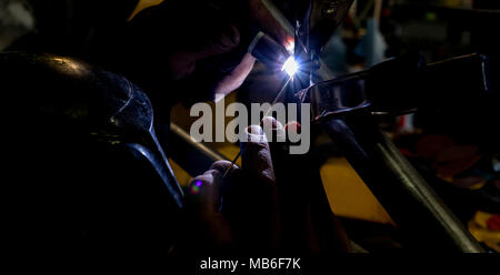 Man tig welding with brilliant bright white star burst bloom of light Stock Photo