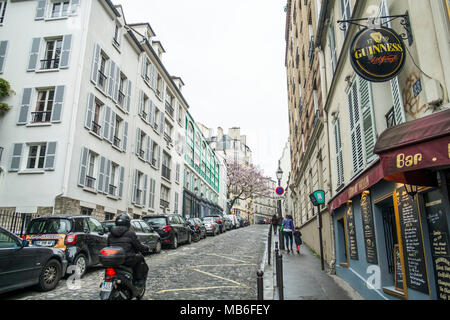 A scooter whizzes up the fabulous Rue Tholoze in Montmartre, Paris. Stock Photo