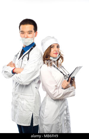 Happy team of two physicians standing back to back with arms folded isolated on white background Stock Photo