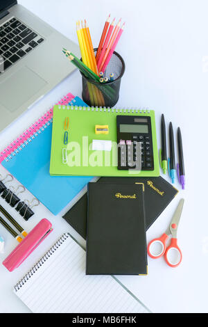 Multiple stationery items for office and school and a laptop. Stock Photo