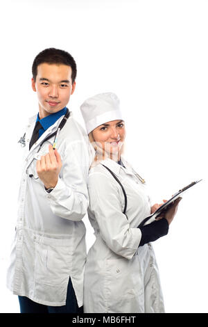 Asian doctor with a smiling happy Caucasian nurse or medical colleague standing back to back with folded arms isolated on white, upper body portrait c Stock Photo