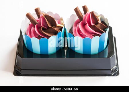 Two M&S Neapolitan Sundae Cakes in plastic tray packaging isolated on white background Stock Photo
