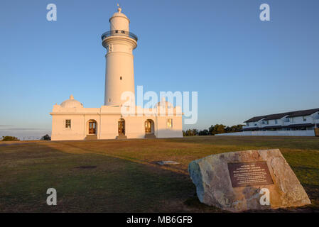 Macquarie Lighthouse at golden hour with the memorial plaque Stock Photo