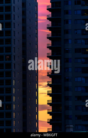 A vibrant sunset sky between two high-rise apartment buildings in Sydney, Australia Stock Photo