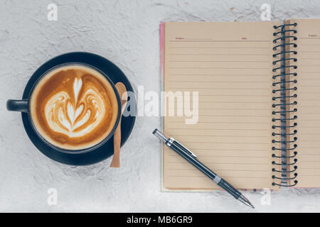An open notebook and pencil , ruler ,ruber with cup of coffee Stock Photo