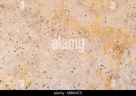 Full frame background texture of orange/peachy cement flooring or wall with small rocks. Stock Photo