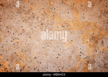 Full frame background texture of orange/peachy cement flooring or wall with small rocks. Stock Photo