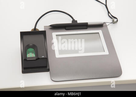 Closeup view of special modern equipment for scanning fingerprints and writing digital signature for biometric id card. Stock Photo