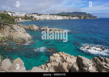 Spain Mediterranean coast with rocks and the village Calella de Palafrugell in background, Costa Brava, Catalonia, Baix Emporda