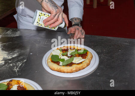 Pizza chef Gerardo demonstrates the art of making a pizza Margherita Stock Photo
