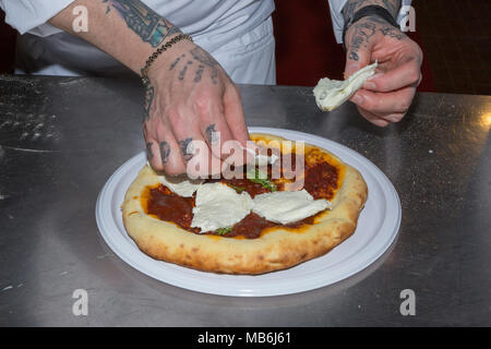 Pizza chef Gennaro Nasti demonstrates the art of making a pizza Margherita Stock Photo