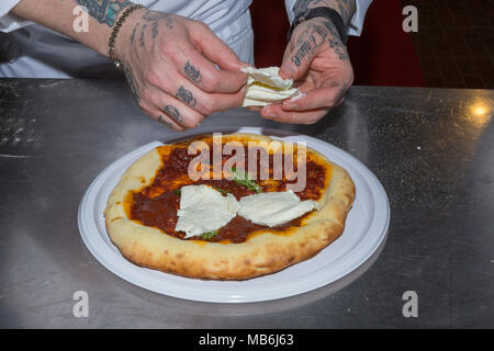 Pizza chef Gerardo demonstrates the art of making a pizza Margherita Stock Photo