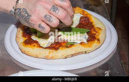 Pizza chef Gennaro Nasti demonstrates the art of making a pizza Margherita Stock Photo