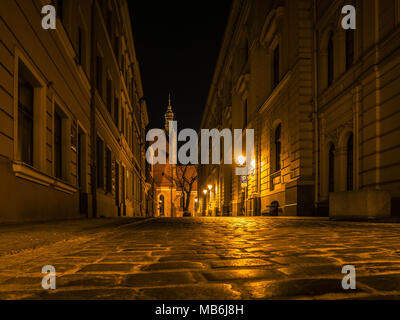 Side street leading towards the Cathedral of Bydgoszcz at night Stock Photo