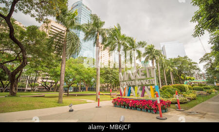 MANILA, PHILIPPINES - NOVEMBER 28, 2017: Ayala Triangle in Makati City, Metro Manila, Philippines. Metro Manila is one of the biggest urban areas in the world with 24 million people. Stock Photo