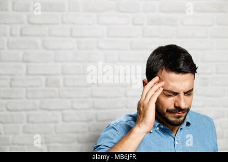 Facial Expressions Of Young Beard Man On Brick Wall Stock Photo