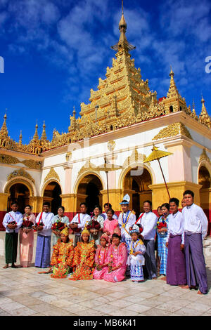 Local people in traditional costumes taking part in wedding ceremony at Mahamuni Pagoda, Mandalay, Myanmar. Mahamuni Pagoda is a Buddhist temple and m Stock Photo