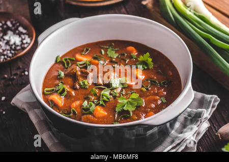 Beef stew with carrots, food photography, lot of herbs inside stew Stock Photo