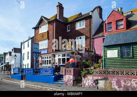 HASTINGS, UK - APRIL 5th, 2018: View of street in seaside town of Hastings with traditional english pub. Hastings is a historic town known for the 106 Stock Photo