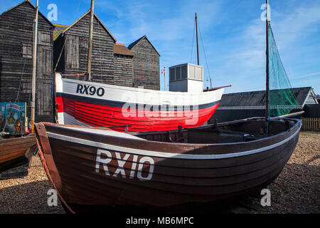 HASTINGS, UK - APRIL 5th, 2018: Boats and net shops in  Hastings, East Sussex. They are traditional storage buildings of the hastings fishing fleet. Stock Photo
