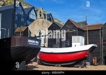 HASTINGS, UK - APRIL 5th, 2018: Boats and net shops in  Hastings, East Sussex. They are traditional storage buildings of the hastings fishing fleet. Stock Photo