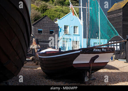 HASTINGS, UK - APRIL 5th, 2018: Boats and old wooden houses in Hastings, East Sussex. Hastings is a historic town known for the 1066 Battle of Hasting Stock Photo