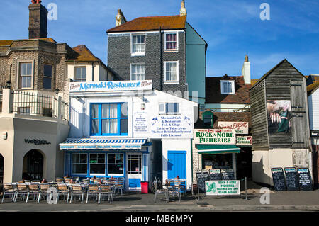 HASTINGS, UK - APRIL 5th, 2018: View of street in seaside town of Hastings with traditional fishery and restaurant. Hastings is a historic town known  Stock Photo