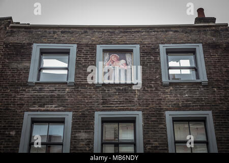 An upstairs woman in the window, above the Newman Arms public house on Rathbone Street, Fitzrovia, London, England, U.K. Stock Photo