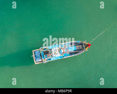 Top view. Aerial view from drone. Royalty high quality free stock footage of the fishing boat on the beach. Fishing boat is mooring on beach alone Stock Photo